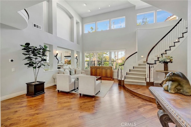 6288 Sunnyside Cir, Huntington Beach, CA 92648 - living area featuring visible vents, a wealth of natural light, wood finished floors, and stairs