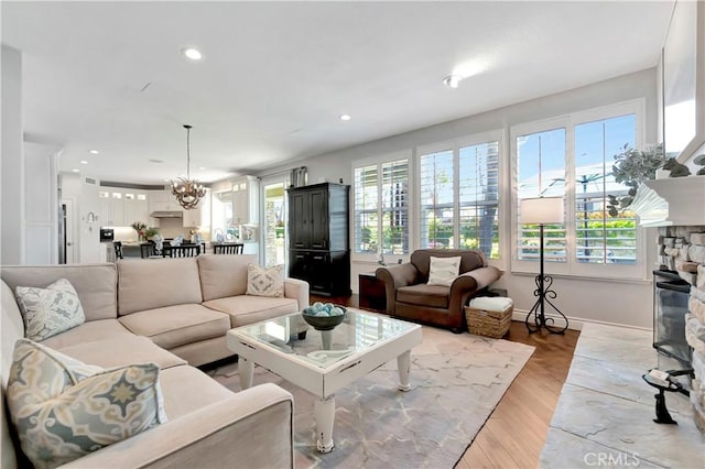 6288 Sunnyside Cir, Huntington Beach, CA 92648 - living area featuring light wood-type flooring, plenty of natural light, recessed lighting, and a fireplace