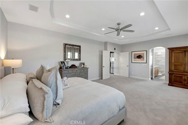 6288 Sunnyside Cir, Huntington Beach, CA 92648 - bedroom with a tray ceiling, arched walkways, light colored carpet, and baseboards