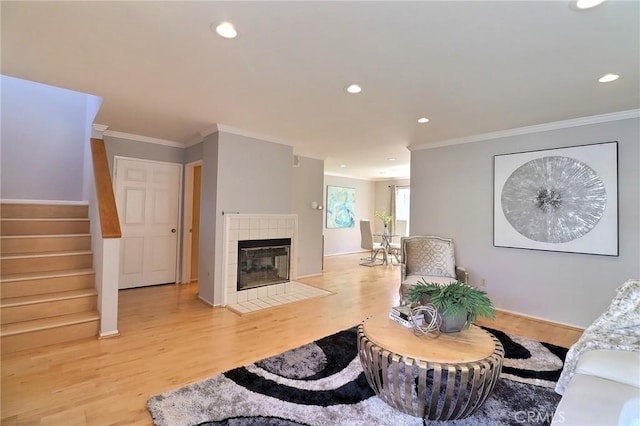 living area with light wood finished floors, recessed lighting, stairs, and crown molding