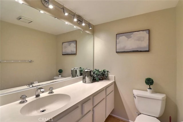 bathroom featuring toilet and vanity