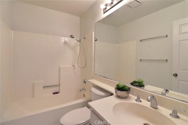 full bathroom with visible vents, shower / bathtub combination, vanity, and toilet