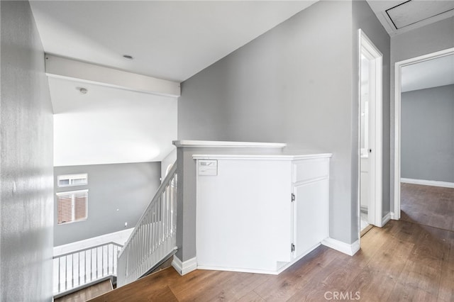 staircase with baseboards and wood finished floors