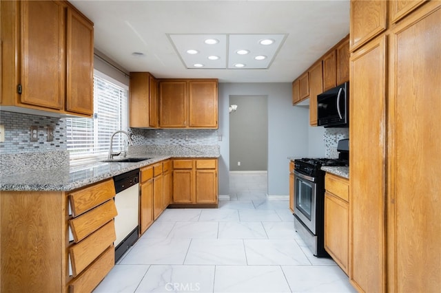 kitchen with white dishwasher, a sink, black microwave, gas stove, and light stone counters
