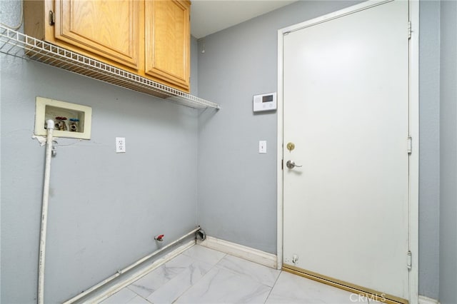 washroom with marble finish floor, washer hookup, hookup for a gas dryer, baseboards, and cabinet space