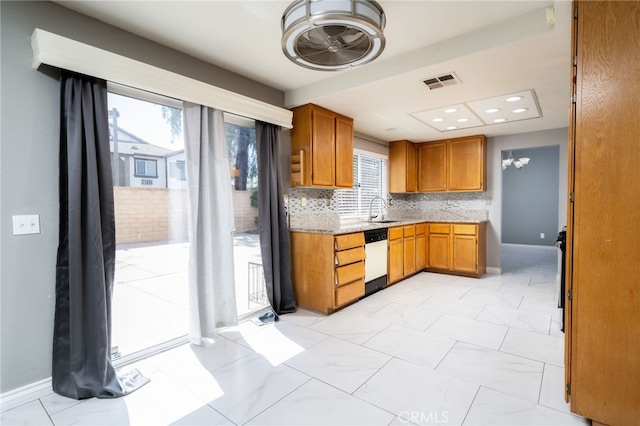 kitchen with visible vents, dishwasher, a sink, brown cabinets, and marble finish floor