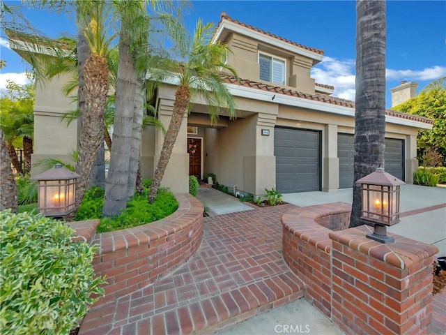 125 Heath Meadow Pl, Simi Valley, CA 93065 - mediterranean / spanish-style home featuring stucco siding, a tiled roof, and driveway