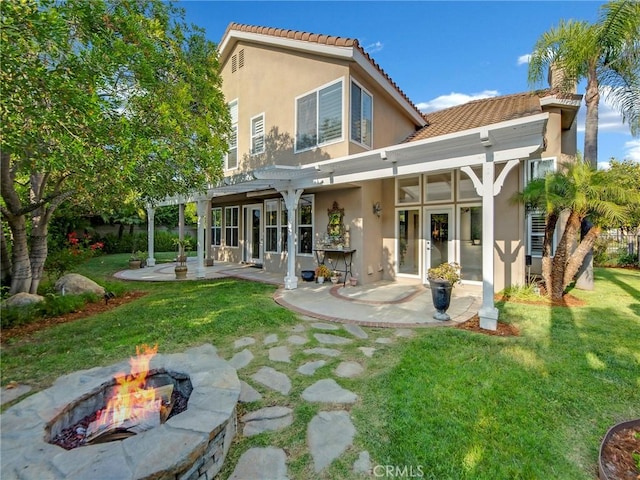 125 Heath Meadow Pl, Simi Valley, CA 93065 - rear view of house featuring stucco siding, an outdoor fire pit, a patio, a tiled roof, and a lawn