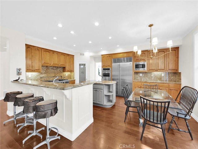 125 Heath Meadow Pl, Simi Valley, CA 93065 - kitchen with built in appliances, recessed lighting, wood finished floors, decorative backsplash, and ornamental molding