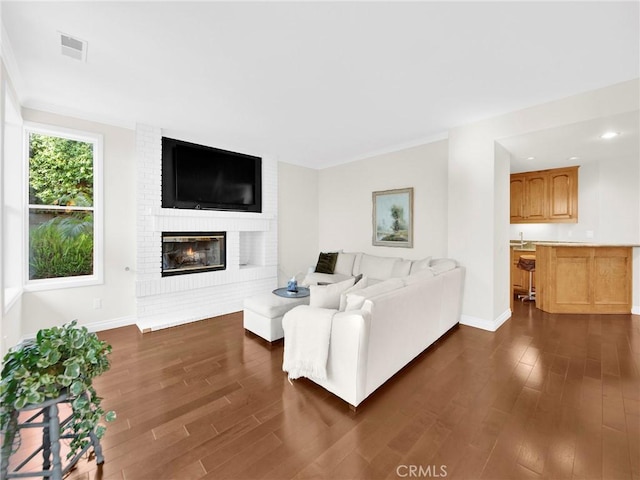 125 Heath Meadow Pl, Simi Valley, CA 93065 - living area featuring dark wood finished floors, a brick fireplace, and recessed lighting