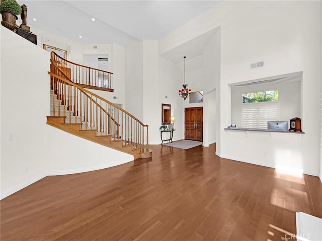 125 Heath Meadow Pl, Simi Valley, CA 93065 - unfurnished living room with stairway, wood finished floors, a towering ceiling, a chandelier, and recessed lighting