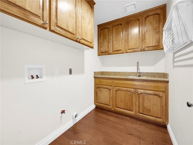 125 Heath Meadow Pl, Simi Valley, CA 93065 - laundry room with cabinet space, washer hookup, gas dryer hookup, and dark wood-style floors
