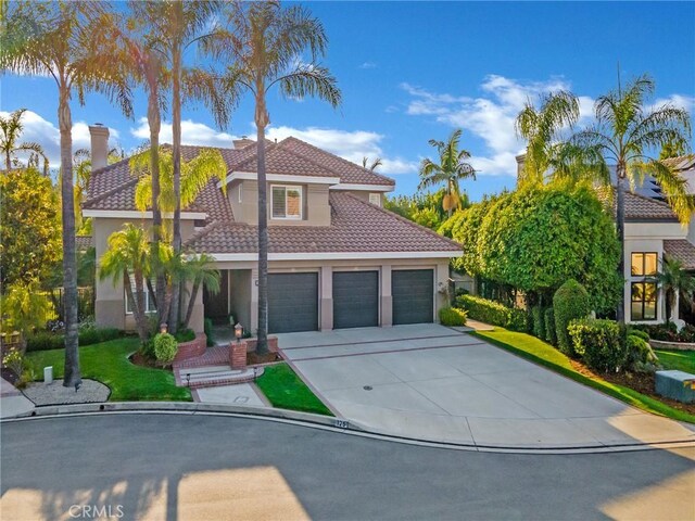 125 Heath Meadow Pl, Simi Valley, CA 93065 - mediterranean / spanish house featuring a tiled roof, driveway, stucco siding, and an attached garage