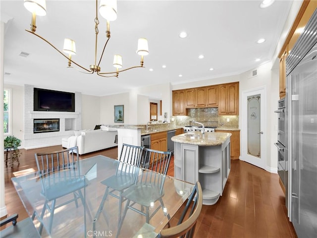 125 Heath Meadow Pl, Simi Valley, CA 93065 - dining area featuring a chandelier, a brick fireplace, dark wood-type flooring, and recessed lighting