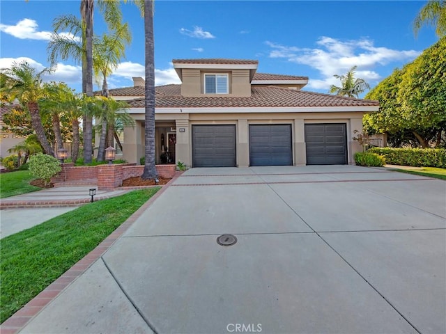 125 Heath Meadow Pl, Simi Valley, CA 93065 - view of front of home featuring driveway, stucco siding, a tiled roof, and a garage