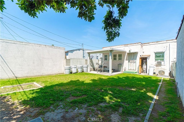view of yard featuring a patio, fence, and ac unit