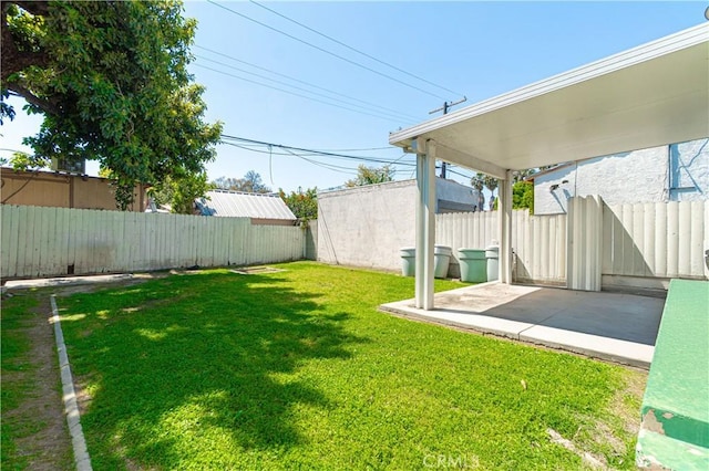 view of yard featuring fence and a patio