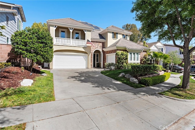 18 Beacon, Ladera Ranch, CA 92694 - view of front facade featuring a balcony, stucco siding, an attached garage, driveway, and a tile roof