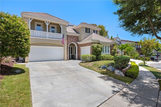 18 Beacon, Ladera Ranch, CA 92694 - view of front of house featuring stone siding, stucco siding, a tile roof, concrete driveway, and an attached garage