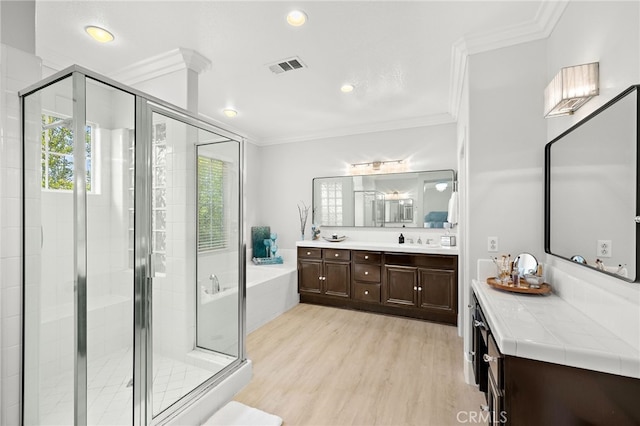 18 Beacon, Ladera Ranch, CA 92694 - full bathroom featuring a bath, vanity, crown molding, a stall shower, and wood finished floors