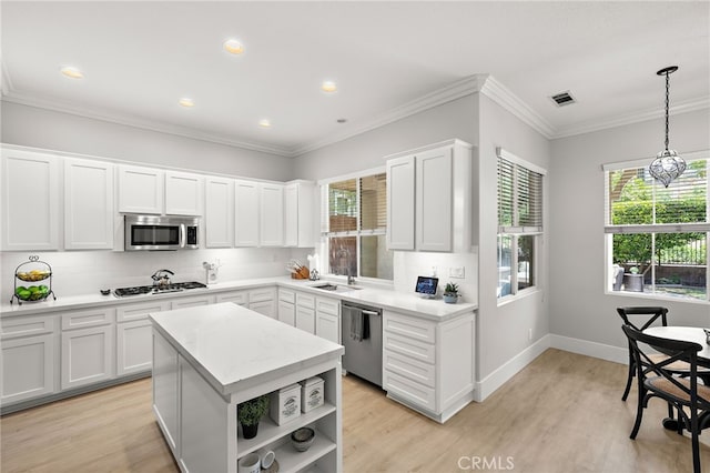 18 Beacon, Ladera Ranch, CA 92694 - kitchen featuring stainless steel appliances, open shelves, backsplash, light wood-type flooring, and white cabinetry