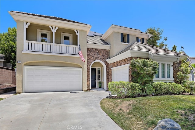 18 Beacon, Ladera Ranch, CA 92694 - view of front of house with stone siding, stucco siding, concrete driveway, and a balcony