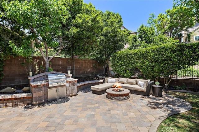 18 Beacon, Ladera Ranch, CA 92694 - fenced backyard featuring a fire pit, a patio area, and exterior kitchen