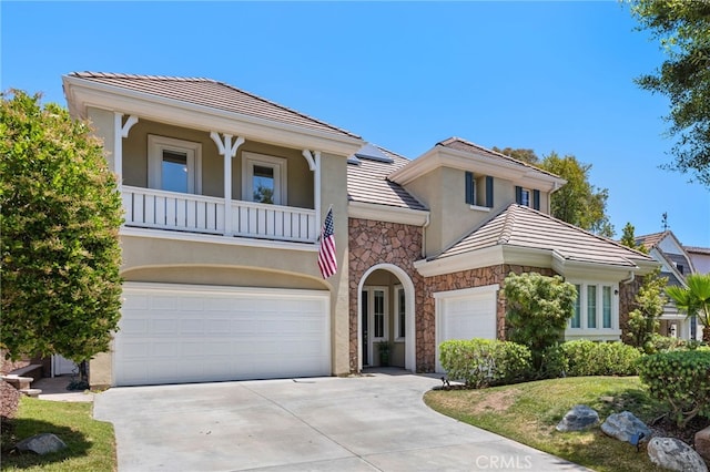 18 Beacon, Ladera Ranch, CA 92694 - view of front facade featuring stone siding, stucco siding, a tile roof, driveway, and a balcony