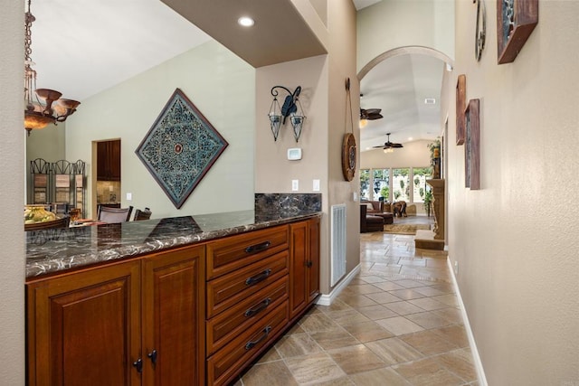 1034 Via Reata, Vista, CA 92081 - bar featuring arched walkways, baseboards, recessed lighting, a ceiling fan, and stone finish floor