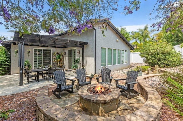 1034 Via Reata, Vista, CA 92081 - rear view of house with stucco siding, a patio area, and an outdoor fire pit