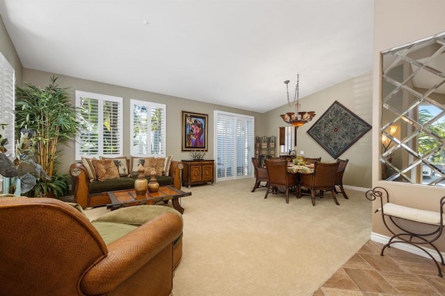 1034 Via Reata, Vista, CA 92081 - living area with light colored carpet, baseboards, and a notable chandelier