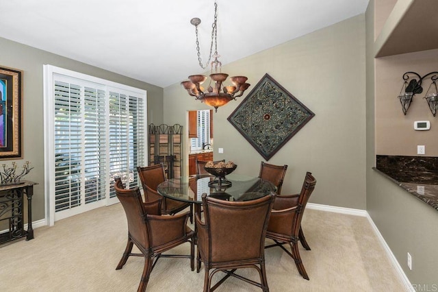 1034 Via Reata, Vista, CA 92081 - dining room featuring lofted ceiling, baseboards, an inviting chandelier, and light colored carpet