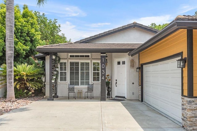 1034 Via Reata, Vista, CA 92081 - view of front of home featuring concrete driveway, a garage, a tiled roof, and stucco siding