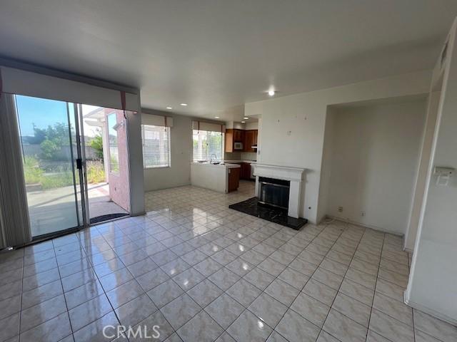 unfurnished living room featuring light tile patterned floors and recessed lighting