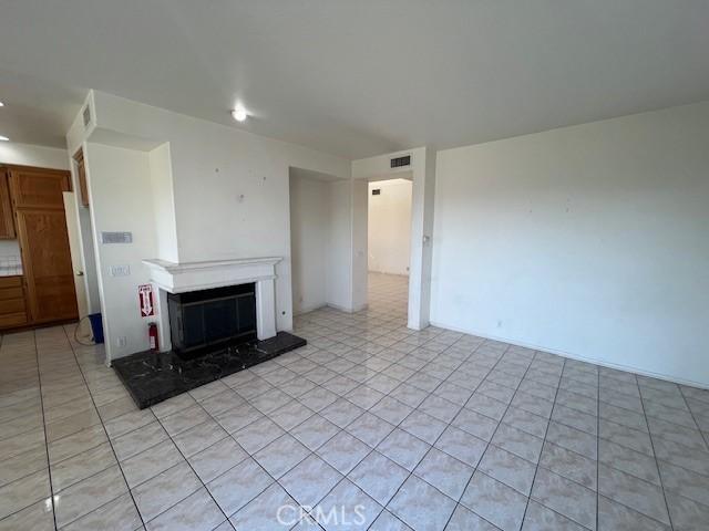unfurnished living room with visible vents and a premium fireplace