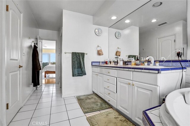 4612 Wolfe Way, Woodland Hills, CA 91364 - full bathroom with ensuite bath, double vanity, tile patterned floors, a tub to relax in, and baseboards