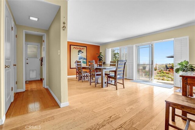 4612 Wolfe Way, Woodland Hills, CA 91364 - dining room featuring light wood-style floors, ornamental molding, and baseboards