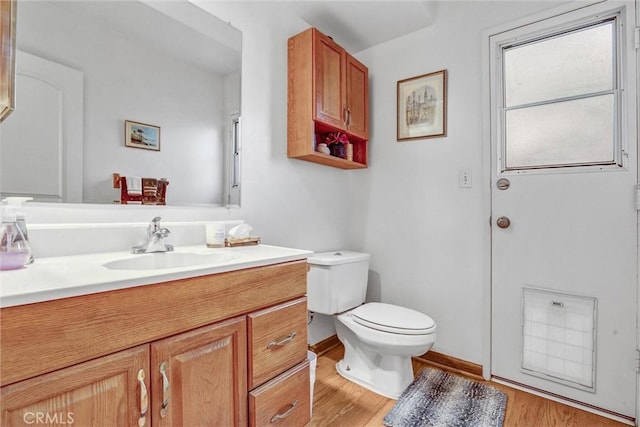 4612 Wolfe Way, Woodland Hills, CA 91364 - bathroom featuring toilet, vanity, wood finished floors, and baseboards