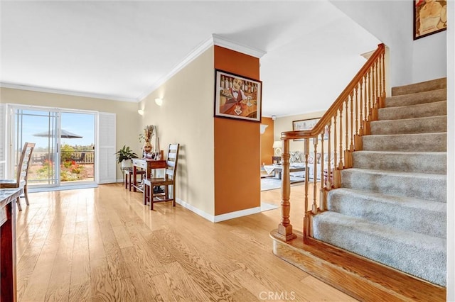 4612 Wolfe Way, Woodland Hills, CA 91364 - staircase featuring crown molding, wood finished floors, and baseboards