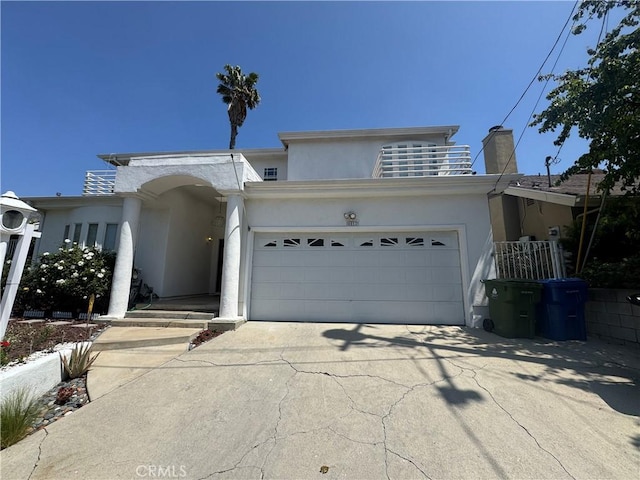 4612 Wolfe Way, Woodland Hills, CA 91364 - view of front of house with concrete driveway, stucco siding, a garage, and a chimney