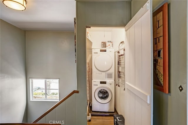 laundry area with stacked washer / dryer and laundry area