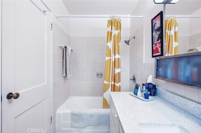 full bath with vanity, backsplash, shower / tub combo with curtain, and tile walls