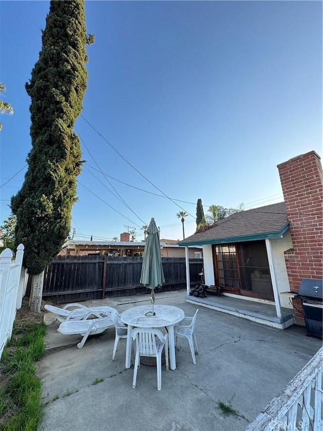 view of patio / terrace with grilling area, a fenced backyard, and outdoor dining area
