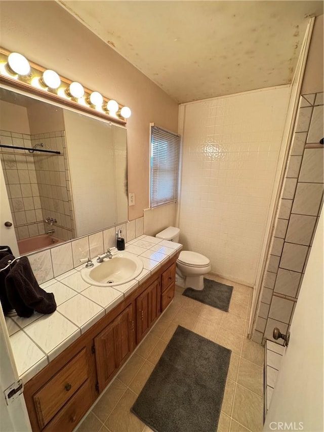 full bath with tile patterned flooring, walk in shower, toilet, and vanity