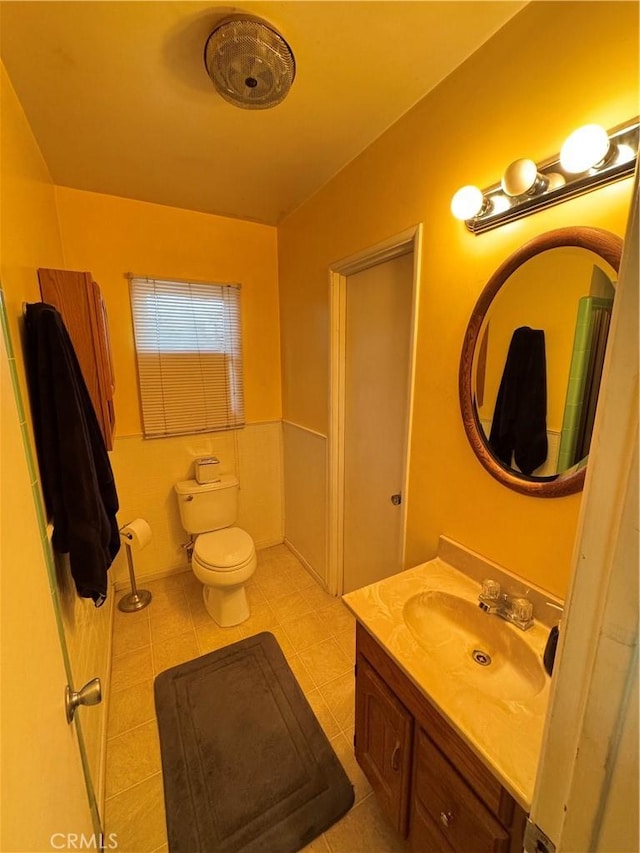 bathroom featuring tile patterned floors, vanity, and toilet
