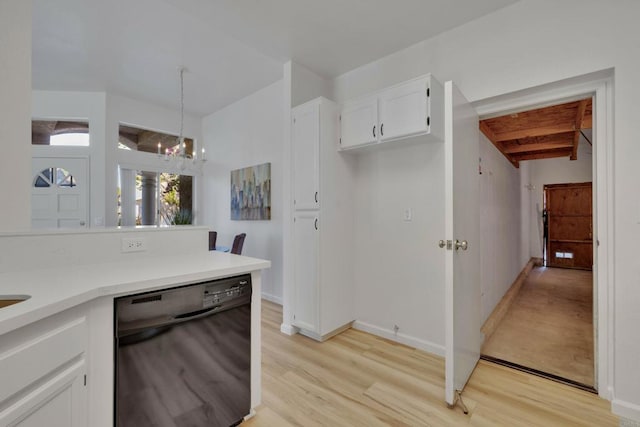 kitchen featuring pendant lighting, light wood-style flooring, white cabinets, a chandelier, and black dishwasher