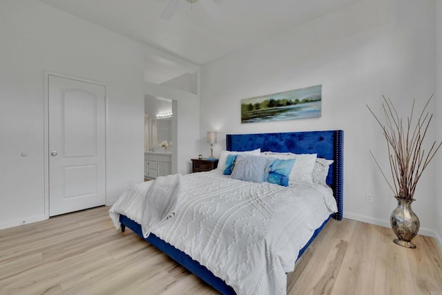 bedroom featuring ensuite bathroom, baseboards, a ceiling fan, and wood finished floors