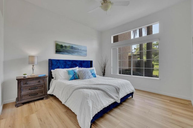 bedroom featuring baseboards, a ceiling fan, and wood finished floors