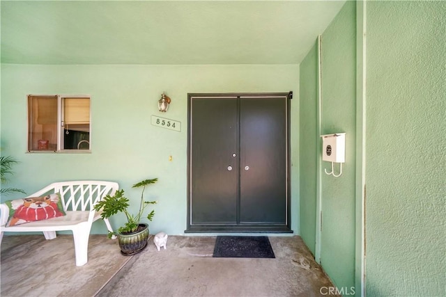 property entrance featuring stucco siding