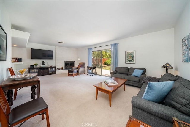 living area featuring a fireplace and carpet
